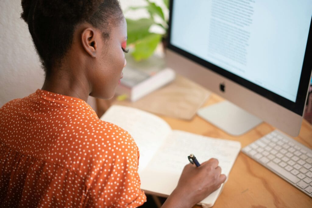remote worker using the best remote work apps 2025 on a laptop in a home office